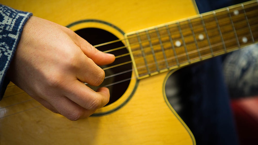 An old Washburn guitar is Ms Davies'  main tool for music therapy