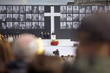 More than 100,000 mourners massed in Warsaw's historic main square at the emotional service.