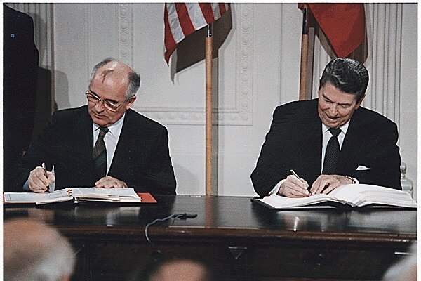 Ronald Reagan and Mikhail Gorbachev sign the INF treaty in the White House.