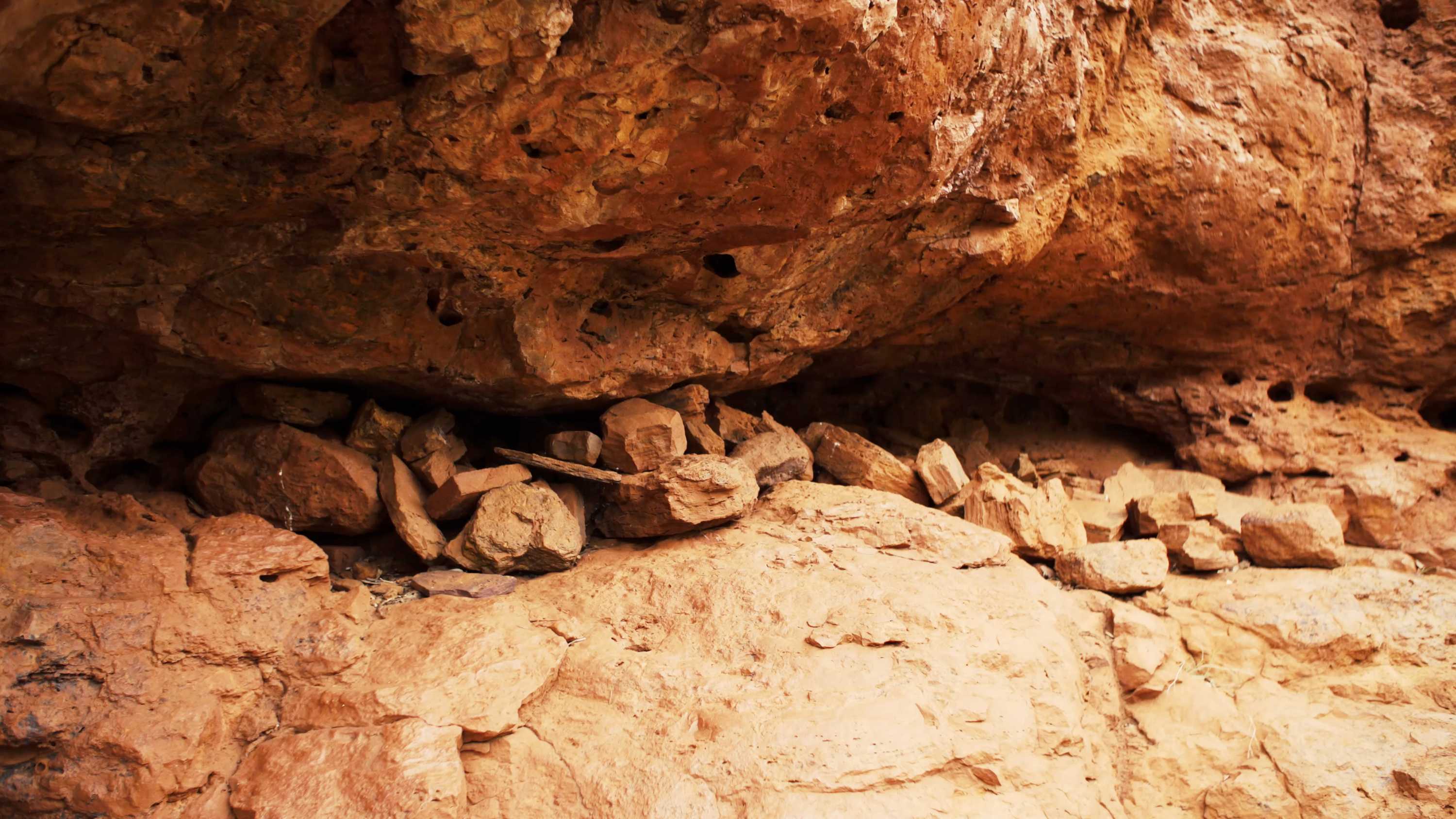 Rocks sit in a cave