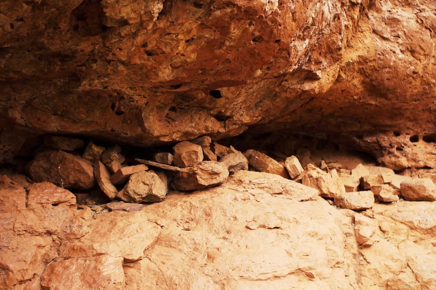 Rocks sit in a cave