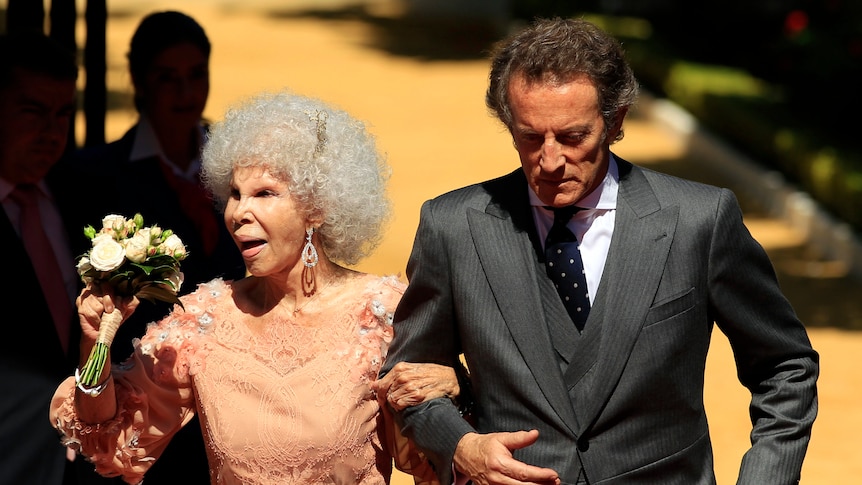 Spain's Duchess of Alba and her husband Alfonso Diez walk to the entrance of Las Duenas Palace after their wedding in Seville.