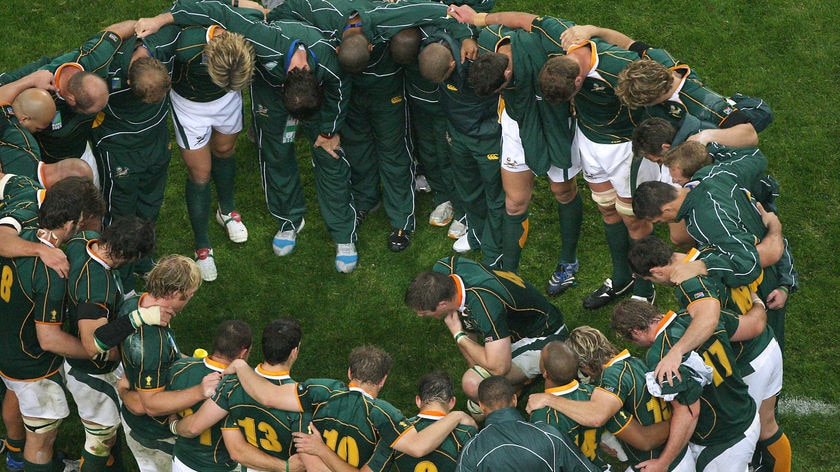 The Springboks huddle after their win