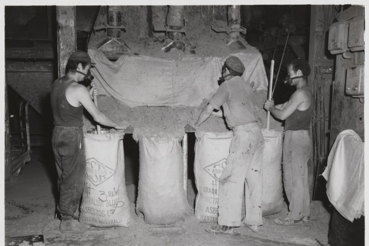 Mine workers bagging asbestos, July 1958. (State Library of WA).jpg