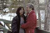 Jeffrey Epstein in a red ski suit embraces Ghislaine Maxwell 