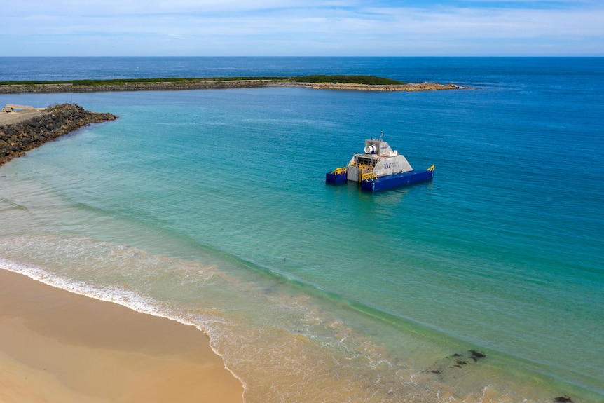 A floating platform in shallow water off a beach.