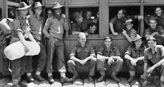 Gunditjmara man Reg Saunders surrounded by his mates of the 2/7th Battalion, in 1943.