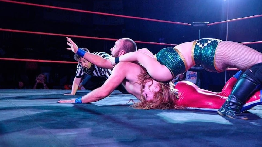 Wrestler Charli Rose pins an opponent to the mat