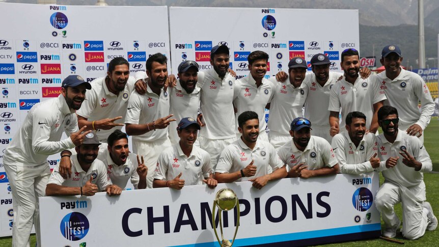 India poses with the Border-Gavaskar Trophy after winning the fourth and final Test in Dharamsala.
