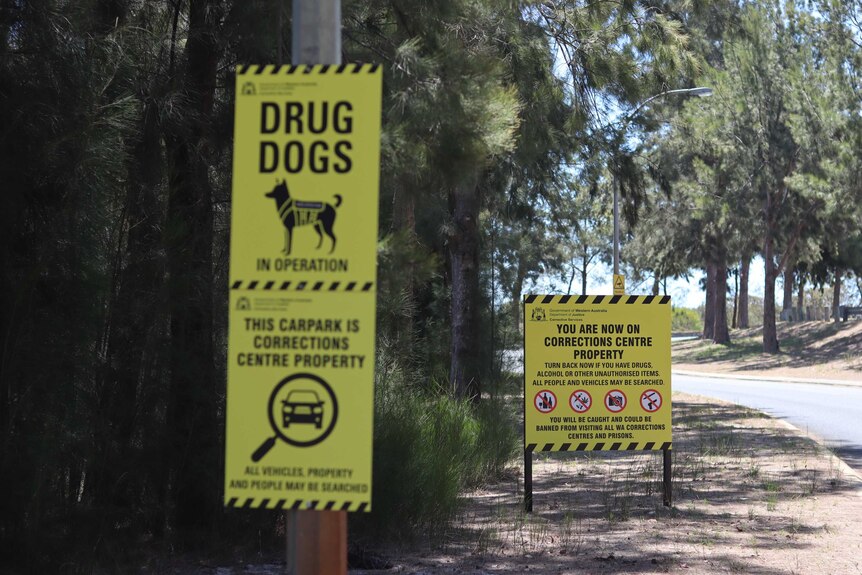 Signage says 'drug dogs' and 'You are now on corrections centre property'