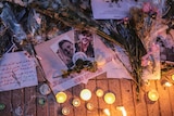 candles and flowers and images of terror victims