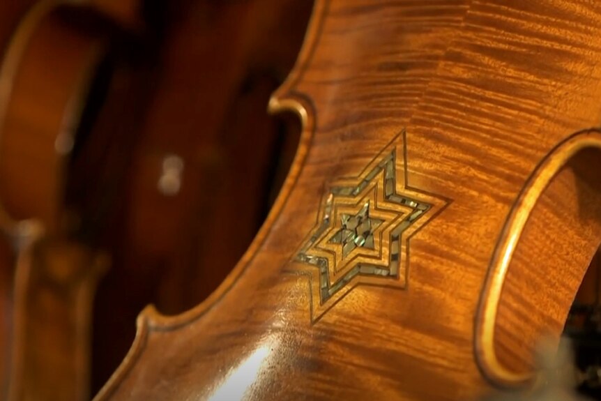 The back of a violin from the Violins of Hope collection,  with a Star of David inlay.