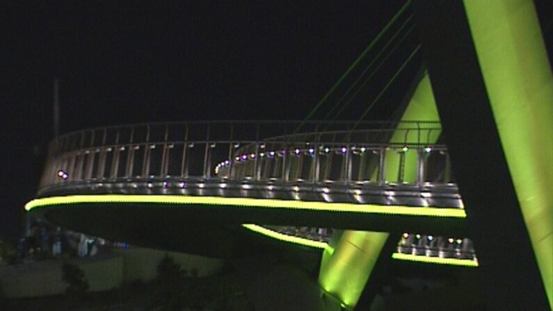 Elizabeth Quay bridge lit up for road safety.