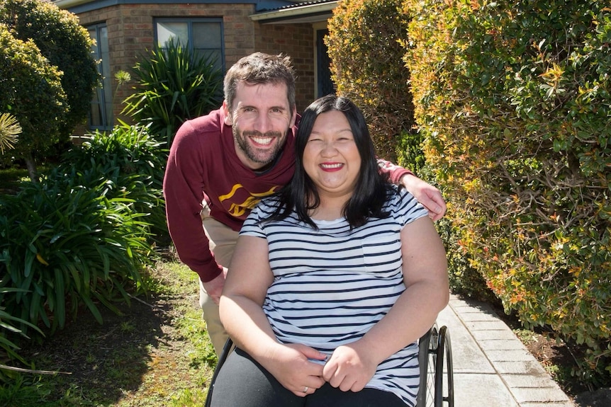 A man and a woman in a wheelchair