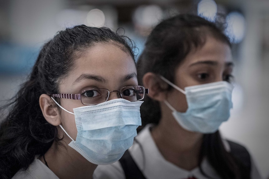 Schoolchildren wear masks at Hong Kong's Tsing Yi MTR station