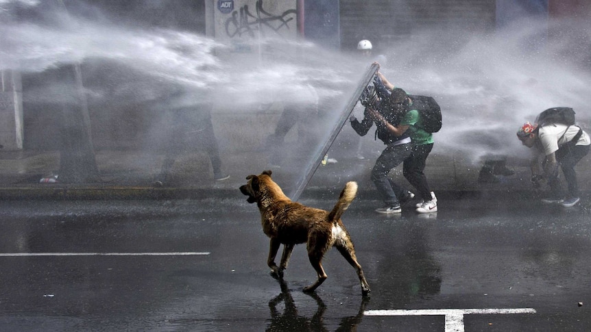 Chilean students clash with riot police in Santiago during a protest to demand educational reform.