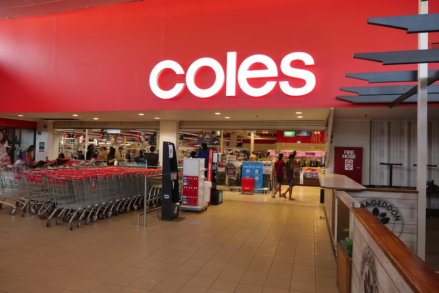 the entry to a Coles supermarket with rows of trolleys 