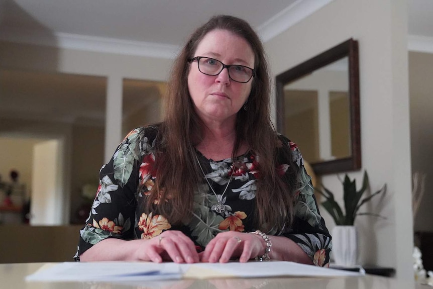 A woman at a desk in a comfortable home.