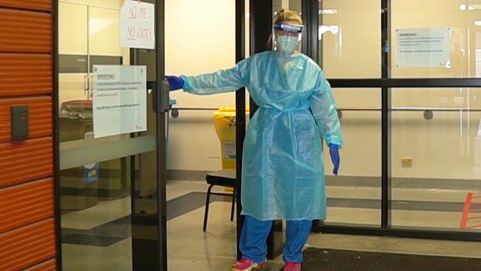 Nurse standing outside clinic at Royal Melbourne Hospital.