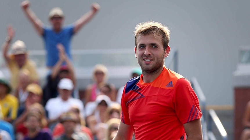 Daniel Evans smiles after defeating Bernard Tomic at the US Open.