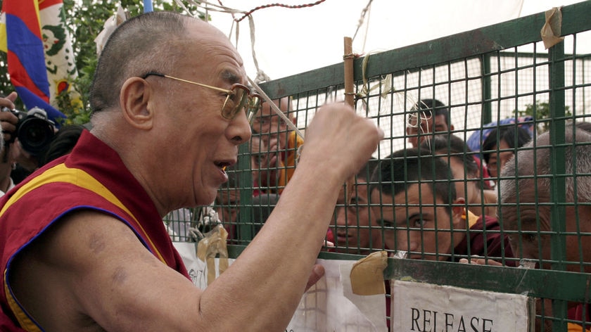 Tibetan spiritual leader, the Dalai Lama, speaks to Tibetan monks on a hunger strike in India