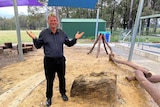 An older man stands in a primary school playground