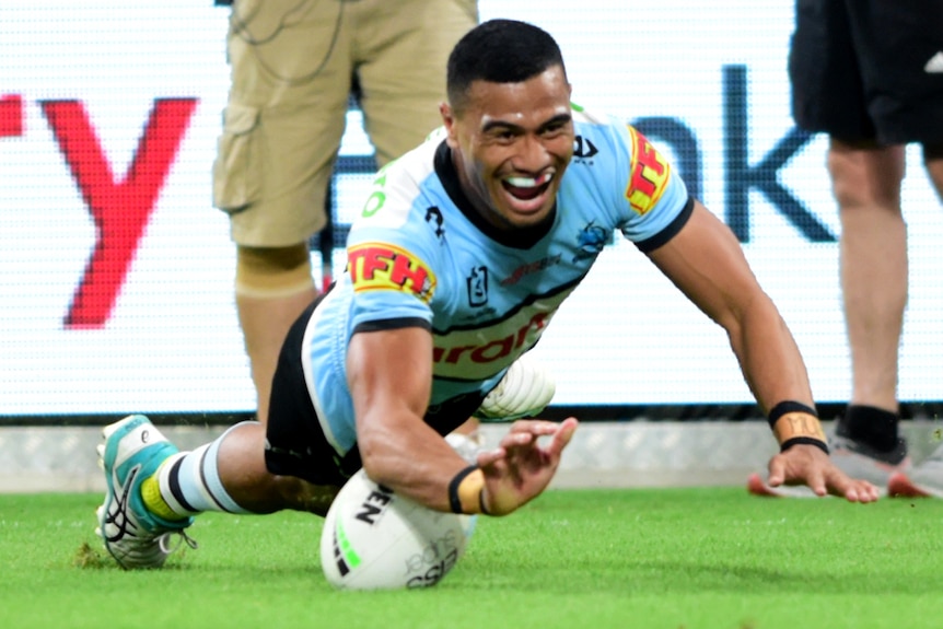 Ronaldo Mulitalo smiles after grounding the ball to score a try