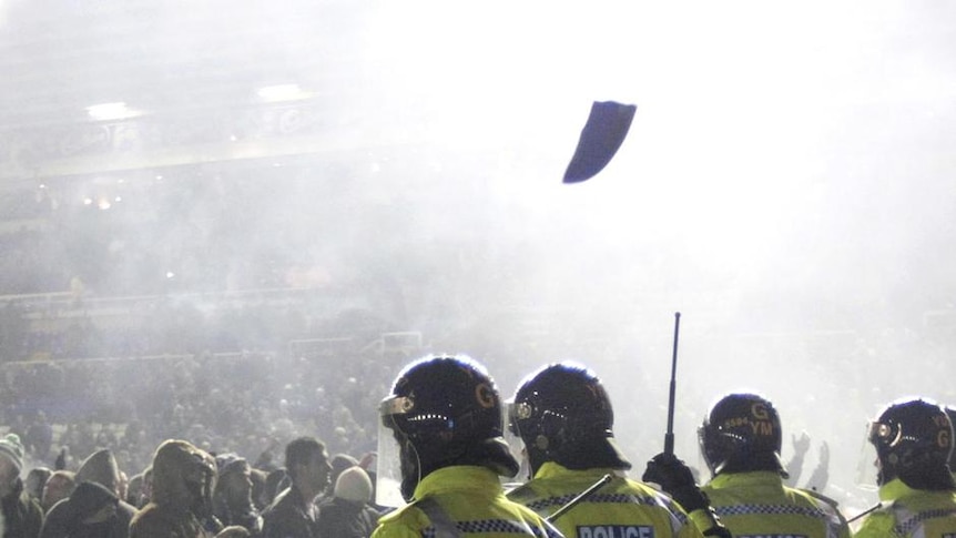Birmingham City fans face up to police after storming the pitch following the team's 2-1 win.