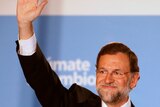 Mariano Rajoy has outlined a freeze on public wages and tax hikes for Spain's wealthiest.