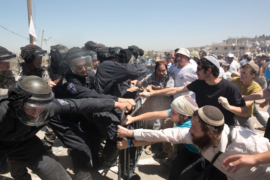 Israeli settlers scuffle with Israeli security forces as the demolition started of the so-called Dreinoff buildings