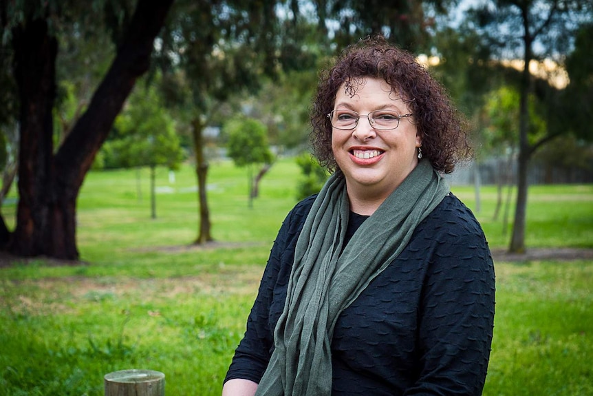 Rosemary Ainley sits in a park.