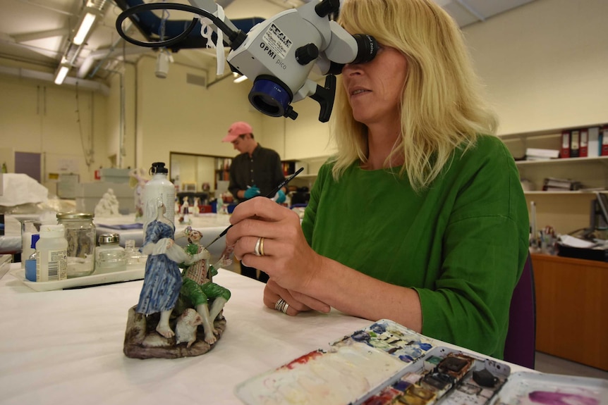 Trude Ellingson works on a microscope to restore on sculpture