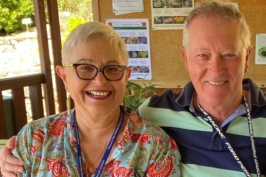 Man and woman sit closely together, smiling