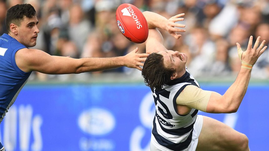 Patrick Dangerfield dodges the ball against North Melbourne