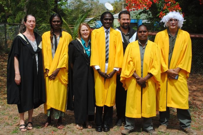 A group of students in gowns graduating