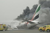 Smoke billows from an Emirates plane on the tarmac at Dubai airport.