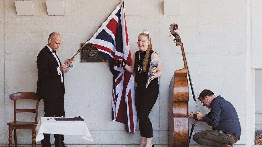 Double bassist Phoebe Russell with union jack, pint of stout and her double bass.