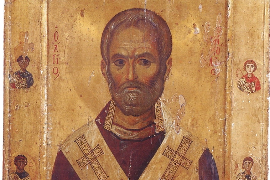 An icon of St Nicholas. He is depicted as having a short brown beard, black eyes, and brown hair. He is wearing a robe. 