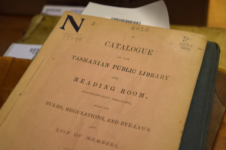 Old library catalogue with yellowed paper, reads "Catalogue" on front