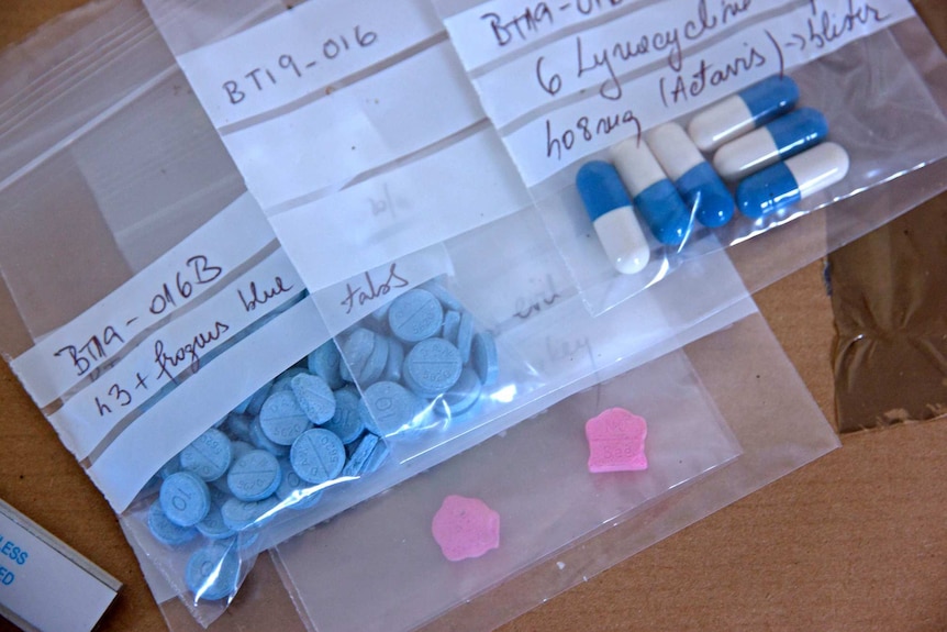 Small labelled plastic bags with pills inside.