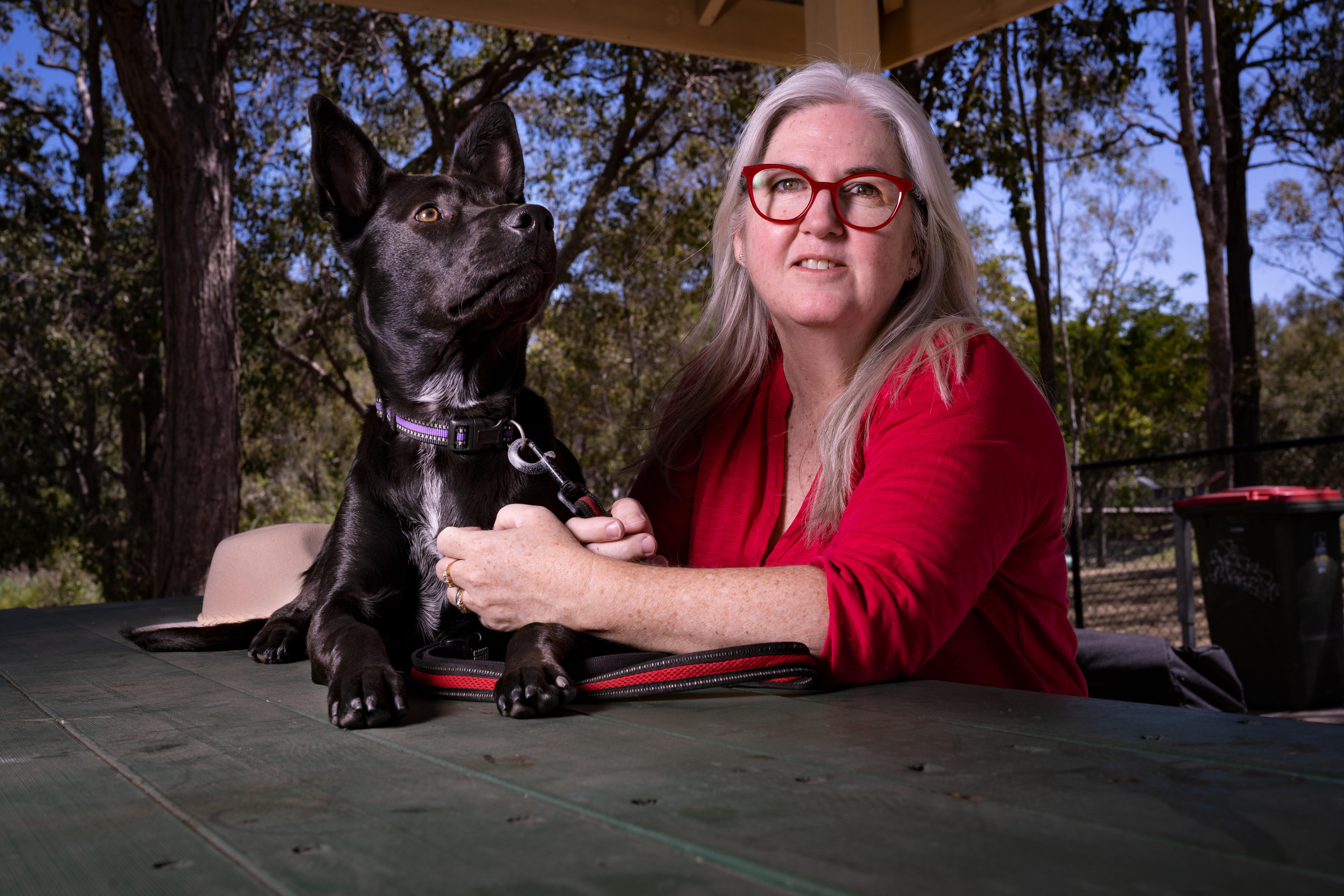 A woman and a black dog 