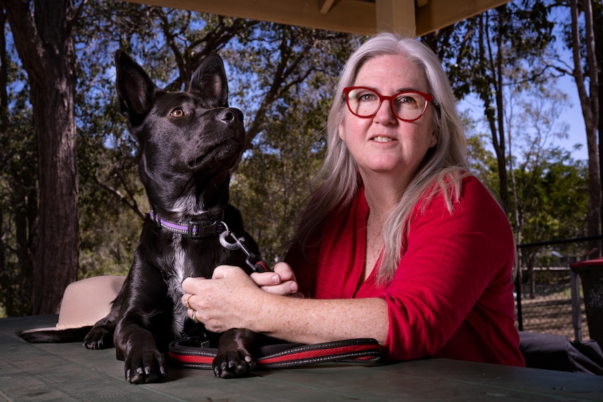 A woman and a black dog 