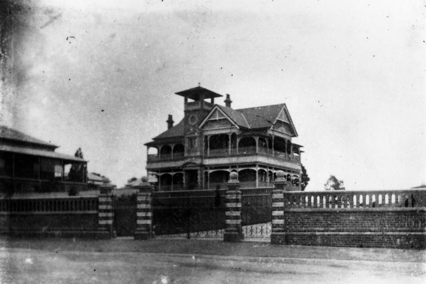 A black and white image of a mansion.