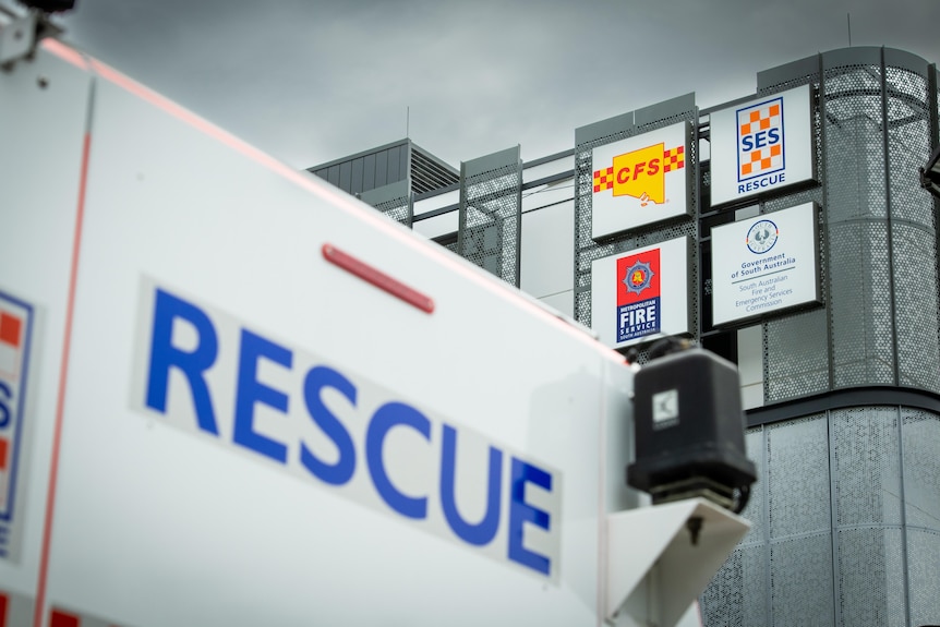 A building with CFS and SES logos, and a truck with 'rescue' written on it in front