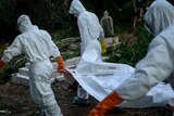 A volunteer medical team carries the body of an Ebola victim.