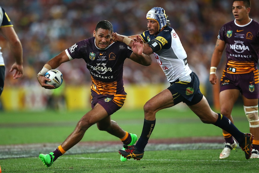 One man chases down an opponent in a rugby league match