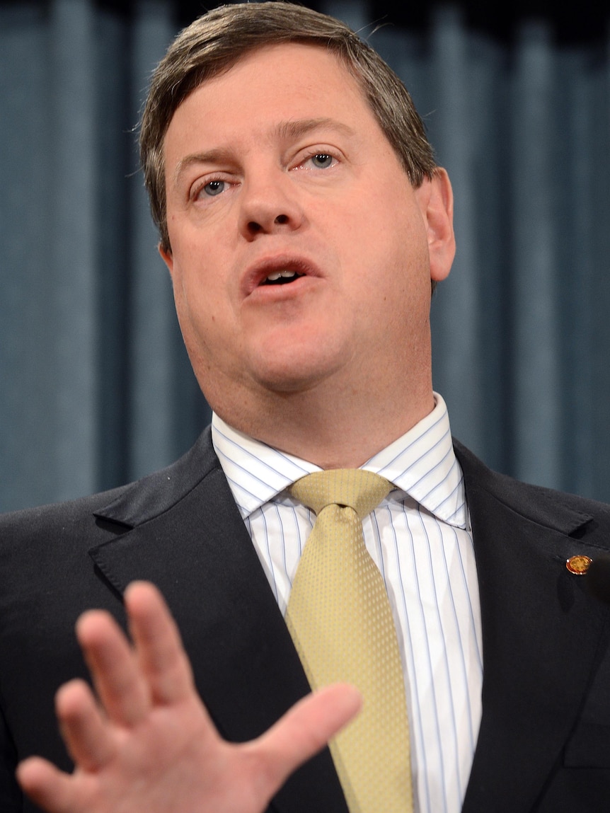 Queensland Treasurer Tim Nicholls gestures during a press conference.