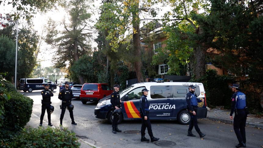 Police stands outside of Ukrainian embassy in Madrid.