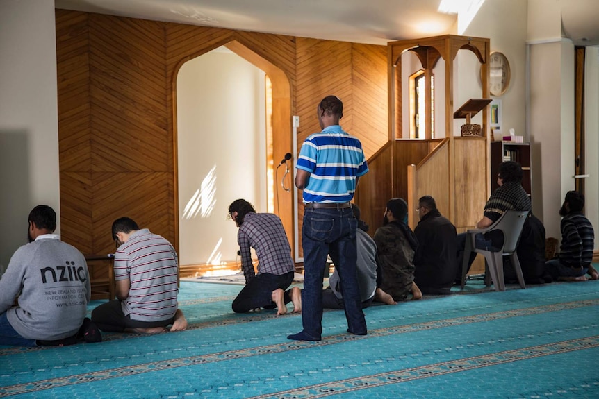 A row of men praying at the Al Noor mosque