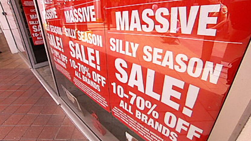 Shop window covered in sales signs advertising "massive" discounts